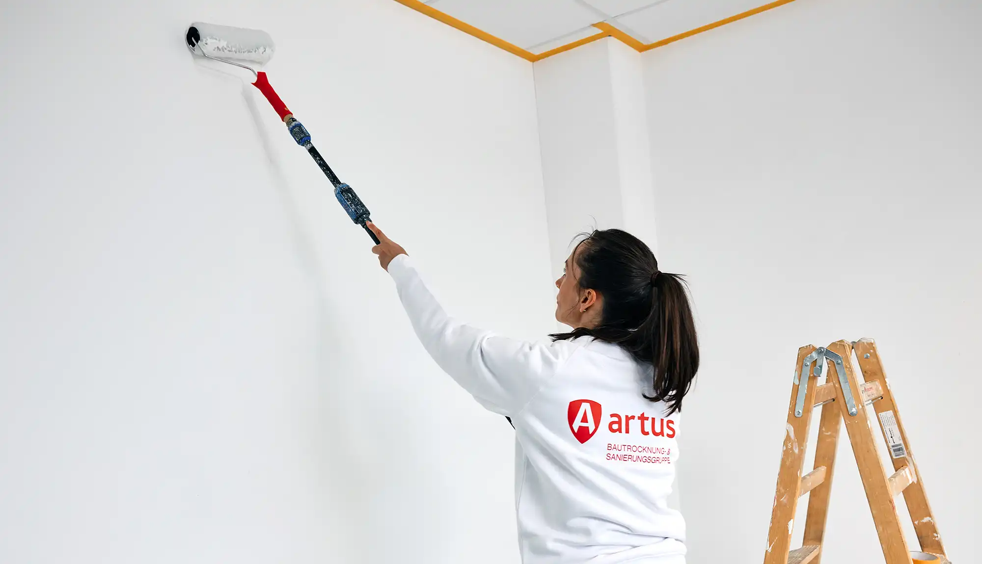 wasserschaden-malerin-mit-farbroller-content